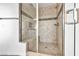 Bathroom with glass-enclosed tiled shower with built-in seat at 9570 Verde Way, Las Vegas, NV 89149