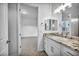 Bright bathroom featuring a granite-topped vanity, modern fixtures, and an open doorway to an adjacent room at 9570 Verde Way, Las Vegas, NV 89149