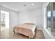 This bedroom features tile flooring, a walk out door and a large window at 9570 Verde Way, Las Vegas, NV 89149
