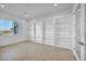 Bedroom with built-in shelving, tile flooring and a large window with views at 9570 Verde Way, Las Vegas, NV 89149