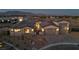 Elegant stucco home featuring a tile roof, desert landscaping, and a spacious three-car garage with brick-paved driveway at 9570 Verde Way, Las Vegas, NV 89149