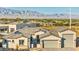 A front exterior with three-car garage, desert landscaping and gated entry at 9570 Verde Way, Las Vegas, NV 89149