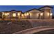 Inviting front yard featuring desert landscaping, a brick driveway, and a gated courtyard for enhanced privacy at 9570 Verde Way, Las Vegas, NV 89149