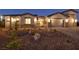Landscaped front yard featuring decorative rocks, shrubbery, and a brick driveway, complemented by a gated courtyard at 9570 Verde Way, Las Vegas, NV 89149