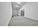A well-lit three-car garage with a large concrete floor and three white garage doors at 9570 Verde Way, Las Vegas, NV 89149