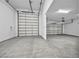 This large three car garage features white walls and doors and a large concrete floor at 9570 Verde Way, Las Vegas, NV 89149