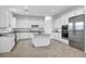 Modern white kitchen featuring an island, stainless steel appliances, and granite countertops at 9570 Verde Way, Las Vegas, NV 89149