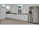Clean and modern kitchen featuring white cabinets, granite countertops, and stainless steel appliances at 9570 Verde Way, Las Vegas, NV 89149