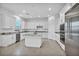 Bright kitchen features white cabinets, stainless steel appliances, a kitchen island and granite countertops at 9570 Verde Way, Las Vegas, NV 89149
