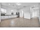 Open-concept living space with kitchen featuring stainless steel appliances, granite countertops, and ample room to move at 9570 Verde Way, Las Vegas, NV 89149