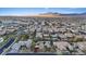 Panoramic aerial view showcasing a well-planned community with various home styles, solar panels, and mountain views at 9668 Doraville Ave, Las Vegas, NV 89149