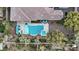 Stunning aerial view of a home showcasing the pool, spa, and lush landscaping in a private backyard oasis at 9668 Doraville Ave, Las Vegas, NV 89149