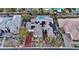 An aerial view of a single-story home, featuring a driveway, desert landscaping, and solar panels on the roof at 9668 Doraville Ave, Las Vegas, NV 89149
