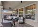 Spacious covered back porch featuring a built-in outdoor kitchen, fire pit, and ample seating for outdoor enjoyment at 9668 Doraville Ave, Las Vegas, NV 89149