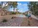 Serene backyard oasis featuring a sparkling pool, spa, and desert landscaping at 9668 Doraville Ave, Las Vegas, NV 89149
