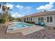 Gorgeous backyard featuring a pool, spa, covered patio, and lush greenery, creating an idyllic outdoor living space at 9668 Doraville Ave, Las Vegas, NV 89149