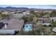 A serene backyard featuring a sparkling swimming pool, lush greenery, and a relaxing patio area at 9668 Doraville Ave, Las Vegas, NV 89149