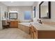 Luxurious bathroom featuring dual sinks, vanity, a soaking tub, and a separate shower at 9668 Doraville Ave, Las Vegas, NV 89149