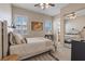 Cozy bedroom showcasing neutral walls, plush carpeting, natural light, and a mirrored closet for an open feel at 9668 Doraville Ave, Las Vegas, NV 89149