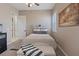 Comfortable bedroom featuring a decorative headboard, neutral walls, plush carpeting, and plenty of natural light at 9668 Doraville Ave, Las Vegas, NV 89149