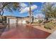 Home exterior featuring a desert-style landscaped front yard and a three-car garage at 9668 Doraville Ave, Las Vegas, NV 89149
