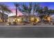 Beautiful home exterior with desert landscaping, mature trees, and evening sky at 9668 Doraville Ave, Las Vegas, NV 89149