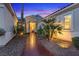 Stunning front entrance of home with a curved walkway flanked by desert landscaping at 9668 Doraville Ave, Las Vegas, NV 89149