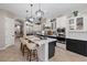 Spacious kitchen with a large island, stainless steel appliances, and elegant lighting fixtures at 9668 Doraville Ave, Las Vegas, NV 89149
