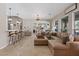 Spacious living room with bar top seating leading to the kitchen and a sectional sofa at 9668 Doraville Ave, Las Vegas, NV 89149