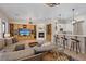 Open-concept living space featuring built-ins, a fireplace, and bar seating at 9668 Doraville Ave, Las Vegas, NV 89149