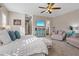 Spacious main bedroom featuring a TV, seating area, and a ceiling fan at 9668 Doraville Ave, Las Vegas, NV 89149