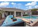 Spacious patio with comfortable seating surrounding a pristine pool, perfect for outdoor gatherings and relaxation at 9668 Doraville Ave, Las Vegas, NV 89149