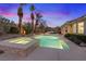 Inviting pool and spa area surrounded by lush landscaping, creating a private backyard oasis under a colorful sky at 9668 Doraville Ave, Las Vegas, NV 89149
