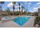 A tranquil swimming pool and spa are surrounded by lush landscaping and palm trees at 9668 Doraville Ave, Las Vegas, NV 89149