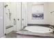 Clean bathroom featuring a glass-enclosed shower, soaking tub, and sleek fixtures at 9938 Regency Canyon Way, Las Vegas, NV 89148