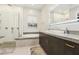 Modern bathroom with a soaking tub, glass-enclosed shower, and stylish vanity at 9938 Regency Canyon Way, Las Vegas, NV 89148