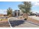 Community entrance featuring modern architecture and desert landscaping at 9938 Regency Canyon Way, Las Vegas, NV 89148