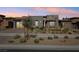 Beautiful modern home with landscaped front yard and neutral colored exterior, complemented by a driveway and two-car garage at 9938 Regency Canyon Way, Las Vegas, NV 89148