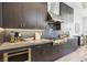 Modern kitchen featuring a gas cooktop, custom cabinetry with under-cabinet lighting, and stylish tile backsplash at 9938 Regency Canyon Way, Las Vegas, NV 89148