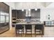 Contemporary kitchen with a large center island, stainless steel appliances, modern pendant lights, and custom cabinetry at 9938 Regency Canyon Way, Las Vegas, NV 89148