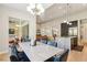 Open-concept space with fireplace, and kitchen featuring modern lighting fixtures at 9938 Regency Canyon Way, Las Vegas, NV 89148
