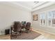 Bright office space with wood floors, two desks, and natural light from shuttered windows at 9938 Regency Canyon Way, Las Vegas, NV 89148