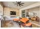 Relaxing outdoor living area with a built-in grill, fireplace, television, and comfortable seating at 9938 Regency Canyon Way, Las Vegas, NV 89148