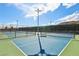 Outdoor pickleball court with green and blue surface and net at 9938 Regency Canyon Way, Las Vegas, NV 89148