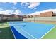 Community tennis court with blue surface and green surroundings at 9938 Regency Canyon Way, Las Vegas, NV 89148