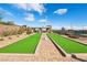 Community walking path with artificial turf and desert landscaping at 9938 Regency Canyon Way, Las Vegas, NV 89148