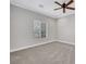 Spacious carpeted bedroom featuring a ceiling fan and a window for natural light at 10120 Cedar Key Ave # 201, Las Vegas, NV 89129