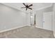Spacious bedroom showcases modern gray walls, plush carpet flooring, crown molding, and a ceiling fan at 10120 Cedar Key Ave # 201, Las Vegas, NV 89129