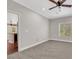 Bright bedroom features plush carpet, base molding, a ceiling fan, and a window overlooking the surrounding neighborhood at 10120 Cedar Key Ave # 201, Las Vegas, NV 89129
