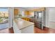 Well-lit kitchen featuring stainless steel appliances, wood cabinets, and an adjacent balcony with scenic views at 10120 Cedar Key Ave # 201, Las Vegas, NV 89129